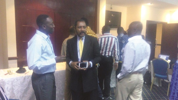 Mr Nanga Kaye (left), Country Coordinator of ENVAC, chatting with some of the participants at the launch